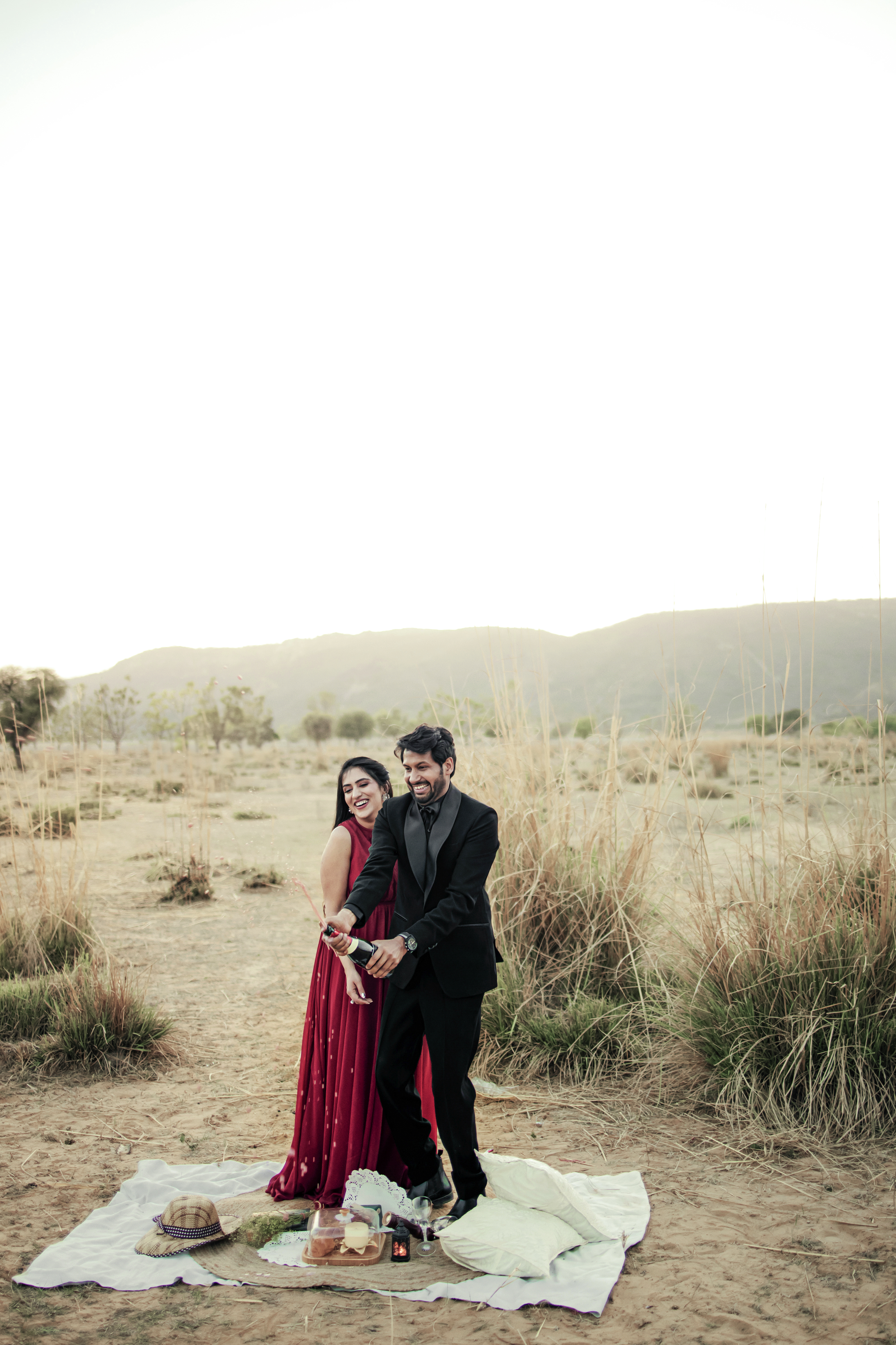Romantic couple walking in grasslands outside Jaipur for pre wedding shoot