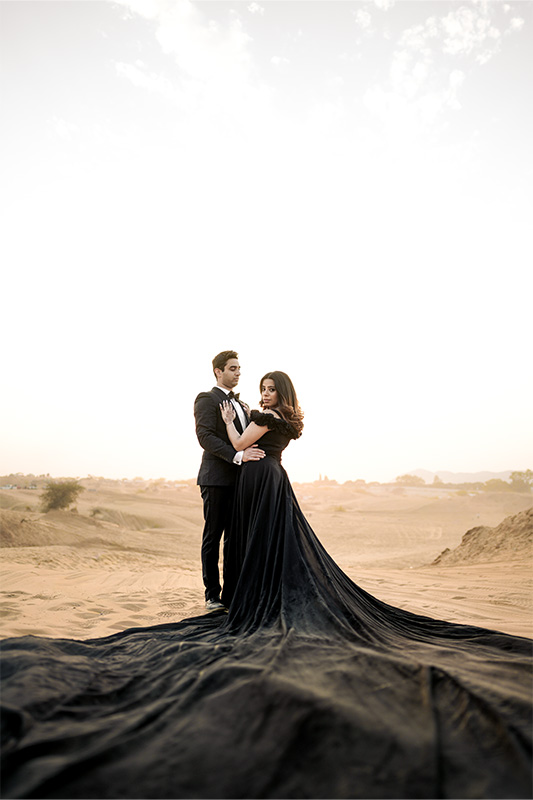 Beautiful desert sunset couple silhouette in Pushkar sand dunes Rajasthan